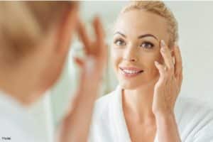 A collection of skincare products, healthy foods, and a serene person meditating, symbolizing various anti-aging secrets for a youthful appearance and well-being.